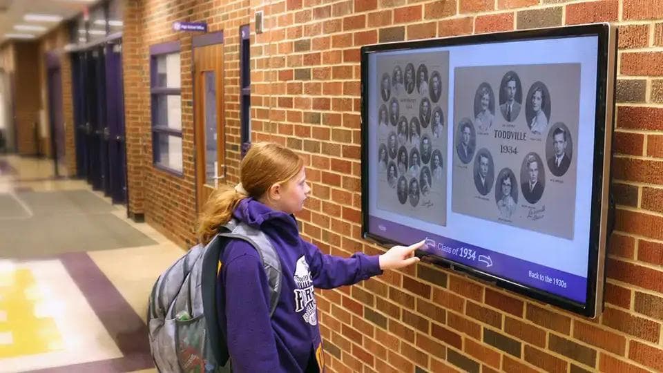 A school history touchscreen wall display.