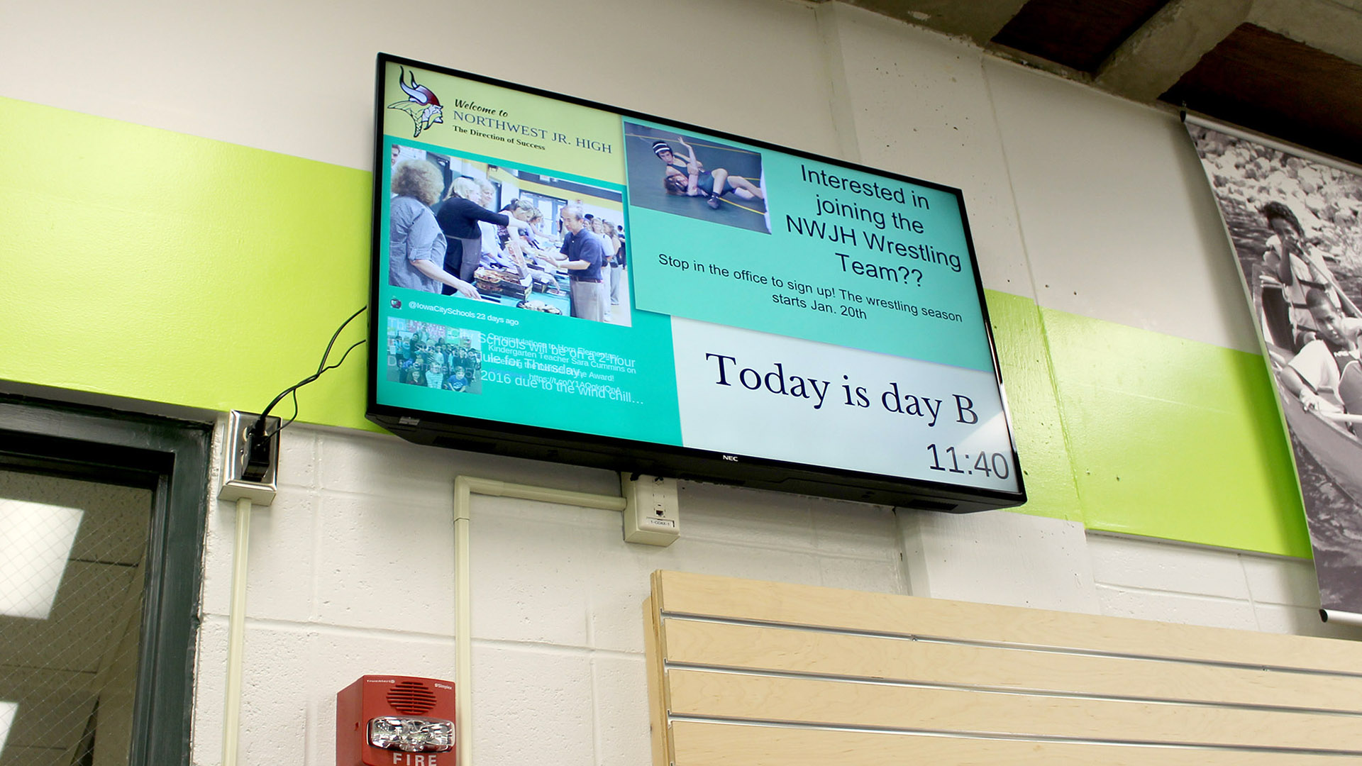 Middle school digital signage content plays on a screen that hangs in the hallway as students go to and from class