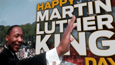 Animated graphic of Martin Luther King waving to a large crowd. Happy Martin Luther King Day is written in the graphic with a waving USA flag