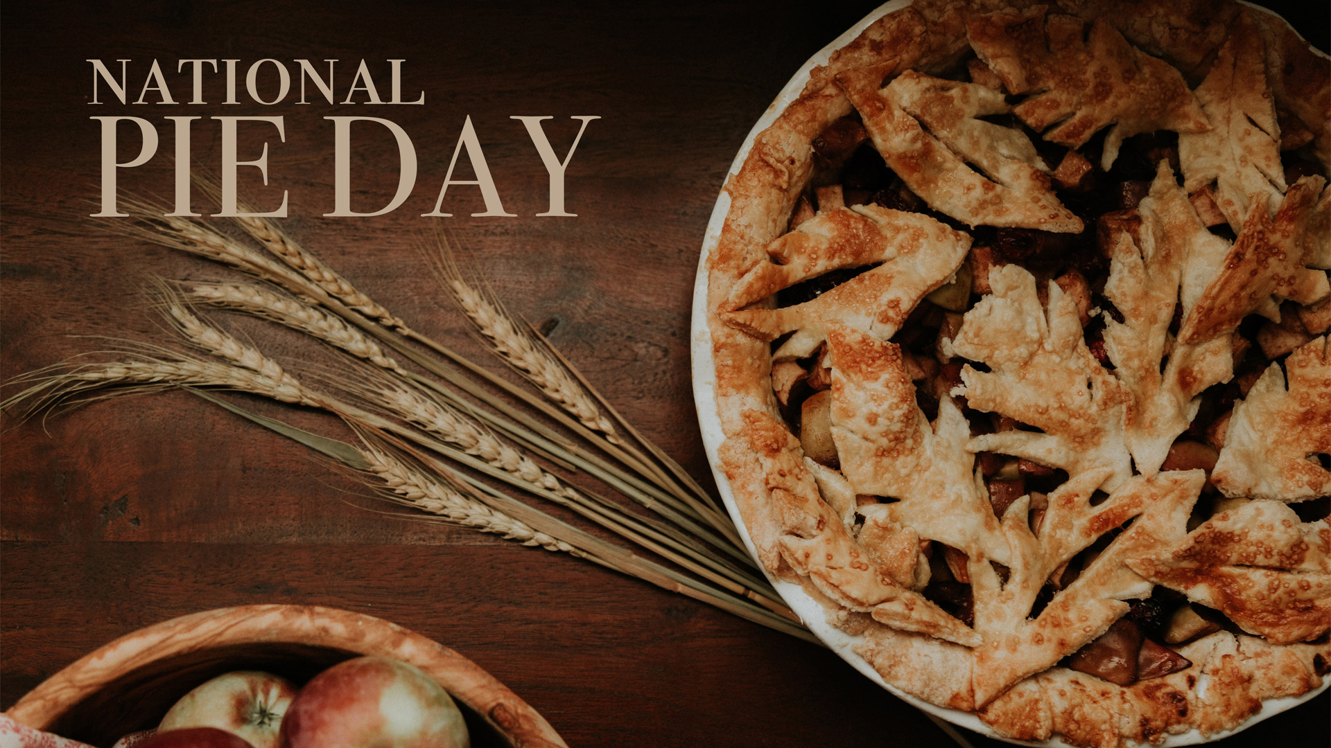 A freshly baked pie is in the top right corner of the photo. There are a couple strands of wheat spanning across the graphic that direct you to the text in the top left corner that reads National Pie Day.