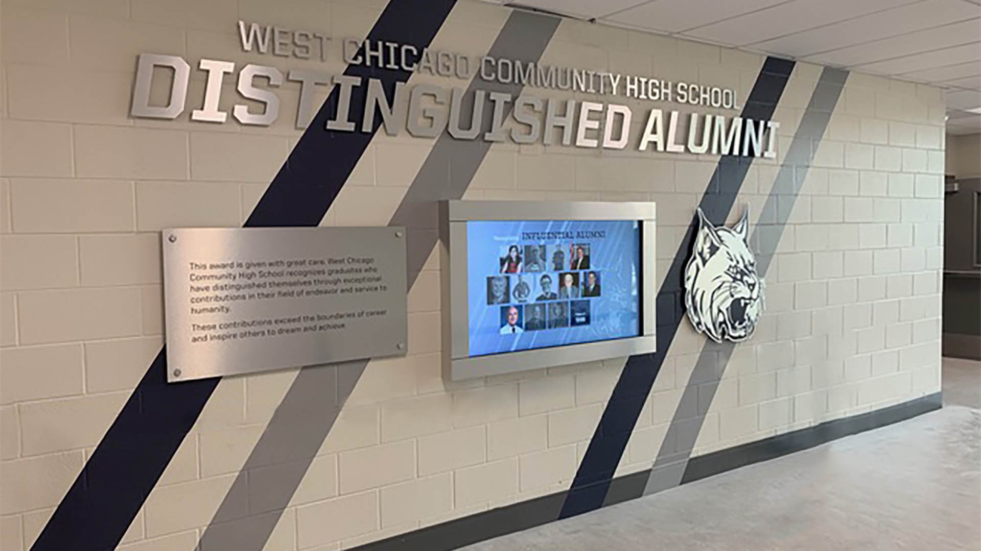 Recognizes distinguished alumni at a high school.  The touch screen display shows Alumni with a photo and bio about each.