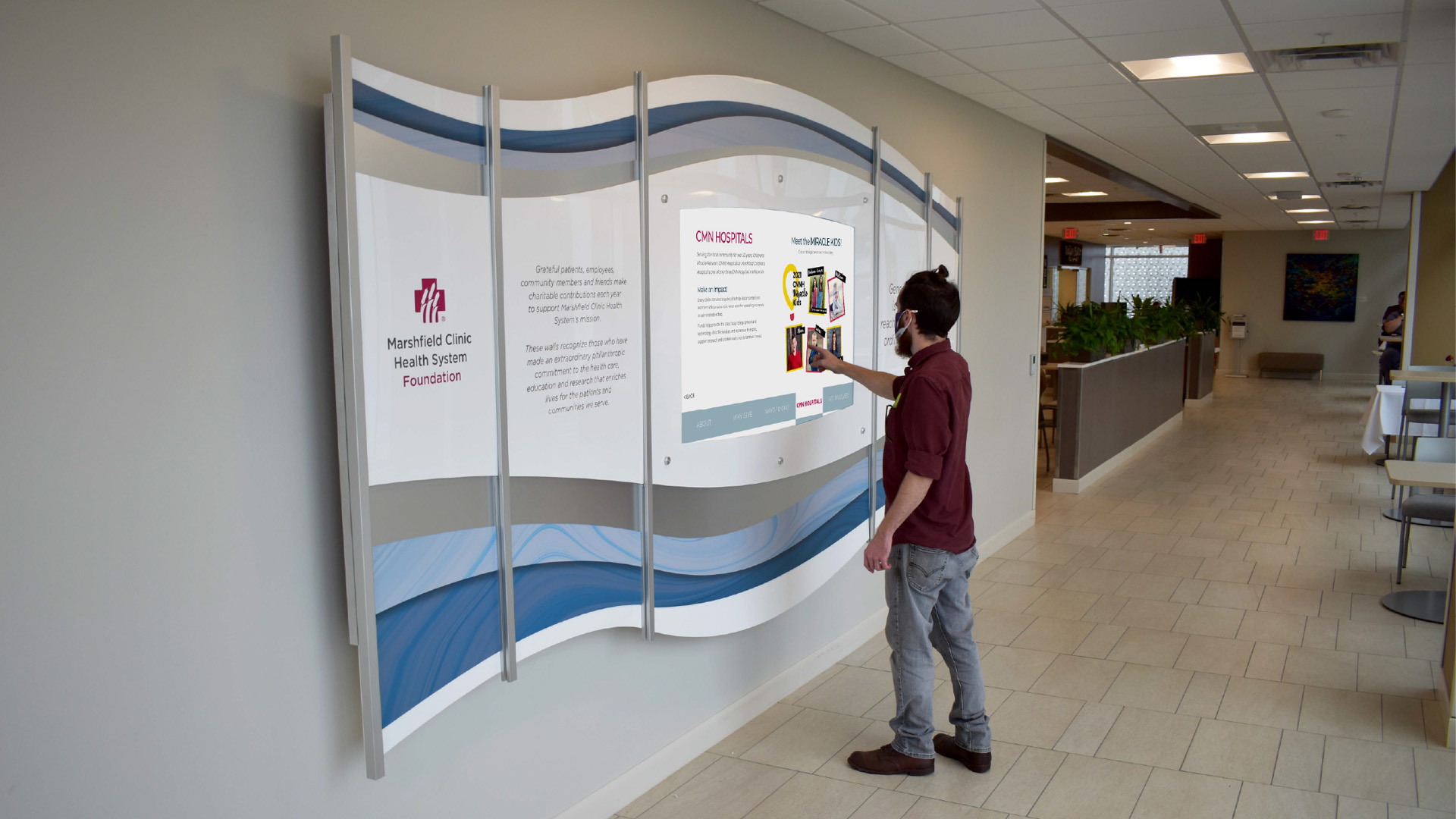 Layered Plexiglass and prints create and attractive surround for this digital donor wall in this medical clinic
