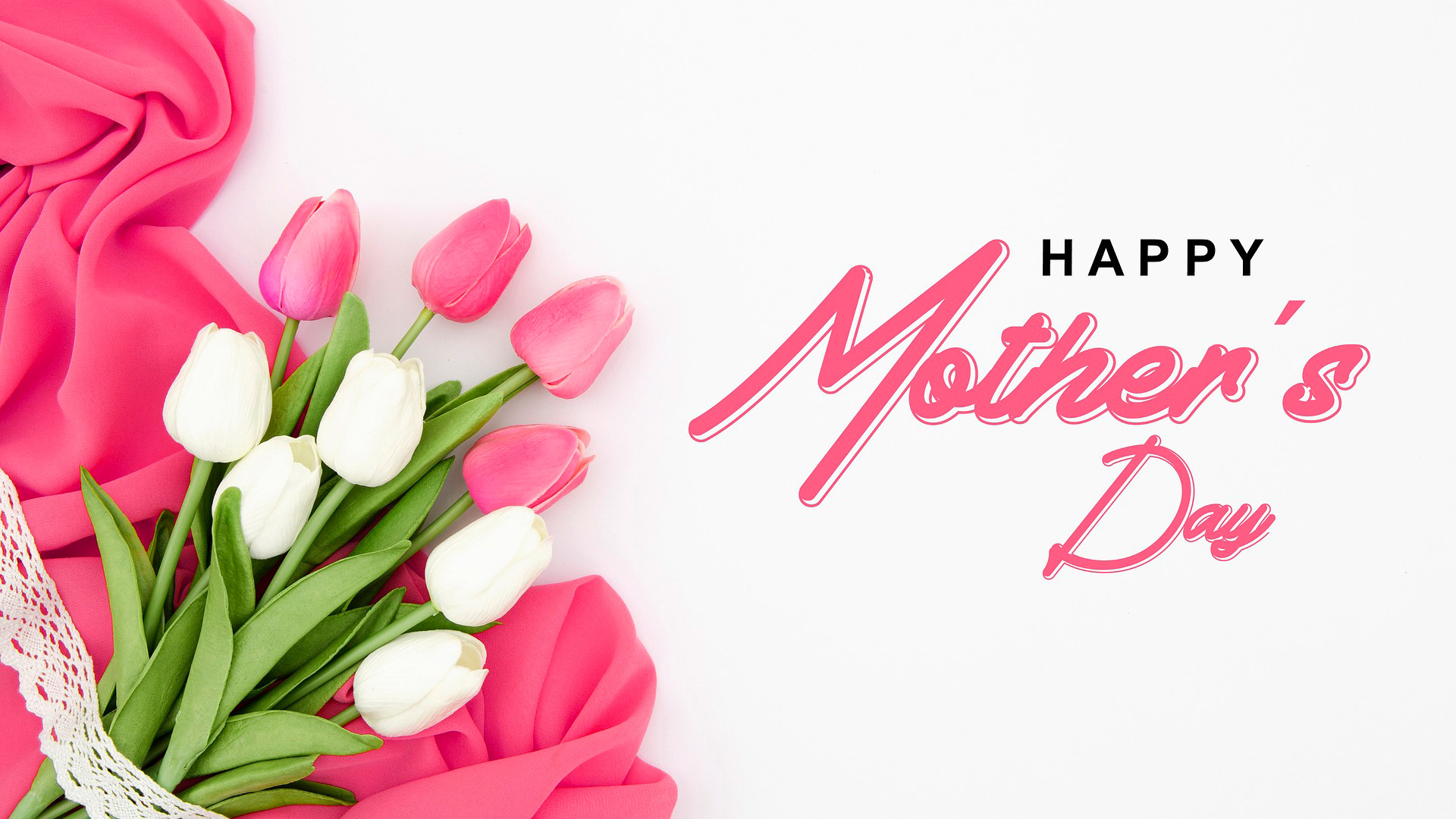 White background with pink and white tulips laying on the left side of the image on top of a pink sheer piece of fabric. On the right side of the page cursive pink text spells out Happy Mother's Day