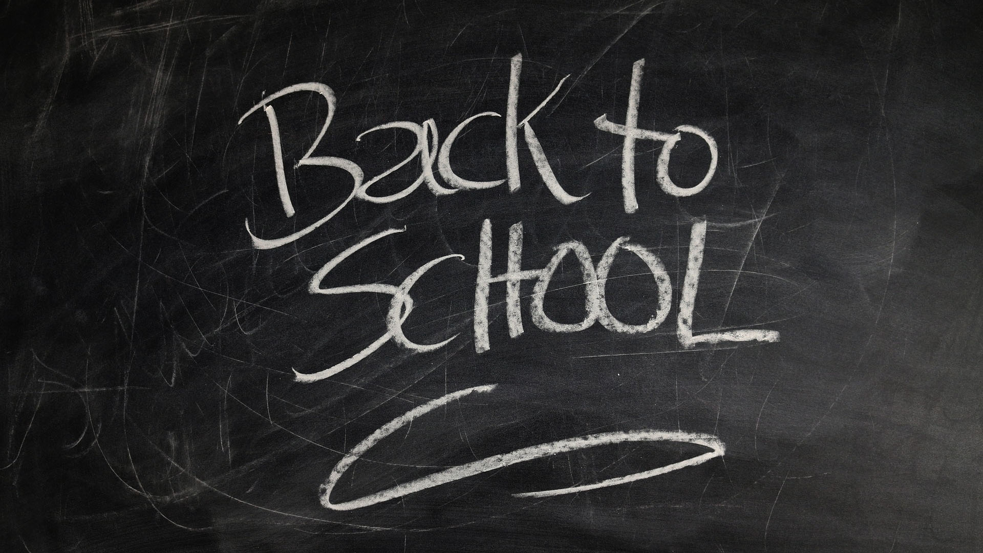 Black chalk board that have white chalk written on it reading, Back to School