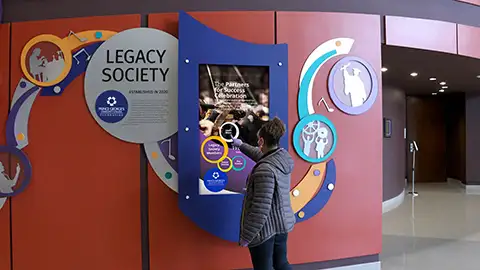 Transforming a performing arts wall with cut out graphics and a digital touch screen donor display