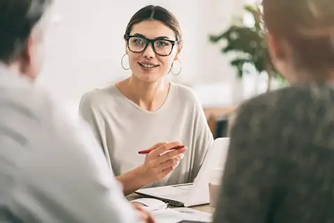 A bank employee meeting with the clients