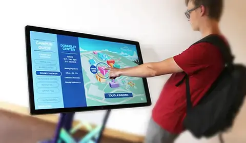 A student is interacting with the campus wayfinding map. The kiosk is free standing and can be moved to any location in a buildign