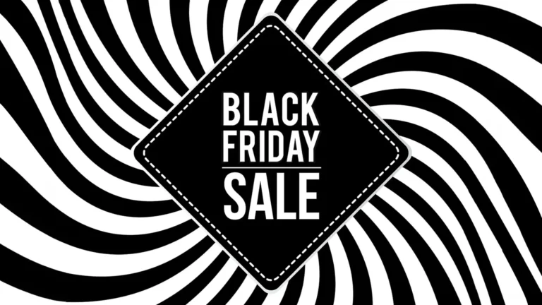 A solid black rhombus shape is centered in the image. Inset across its outside edge of the shape is a white dashed line border. In the very center are the stacked words, “BLACK FRIDAY SALE’ in solid, thick, white sans letters. Between the words ‘Friday’ and ‘sale’ is a thin horizontal white line. Behind the rhombus are a black and white swirled lines.