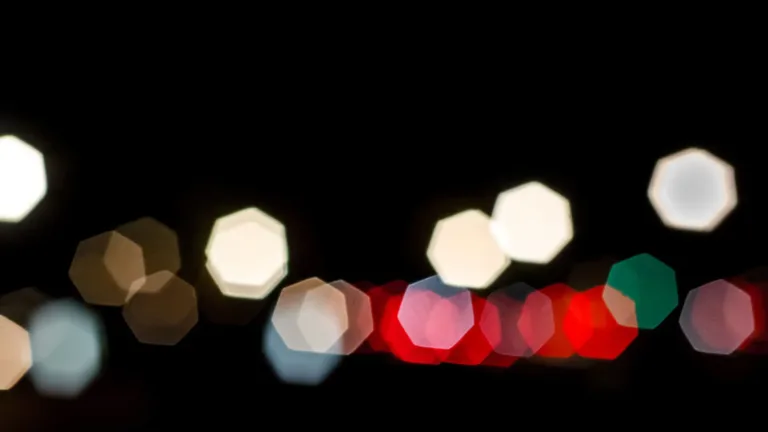 A black image with heptagon shapes scattered near the bottom edge horizontally. The heptagons are various colors and transparencies, including the colors white, brown, green, and red.