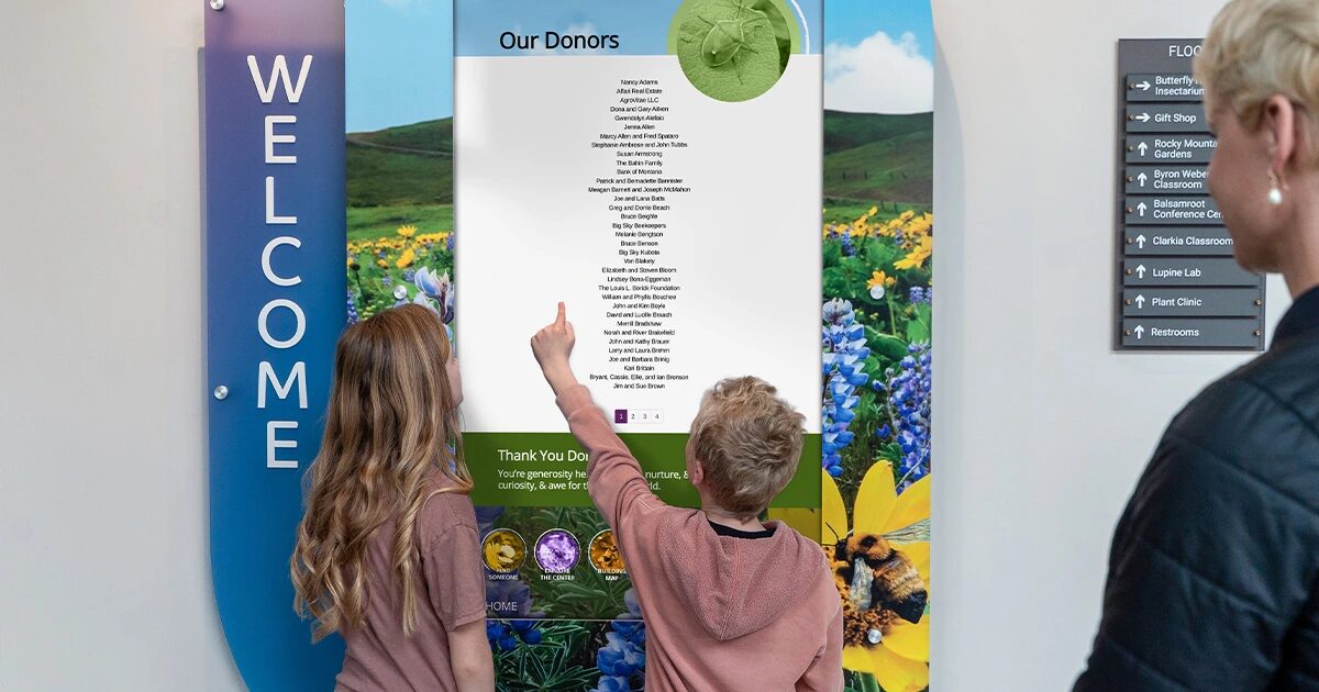 Kids interacting with digital donor wall
