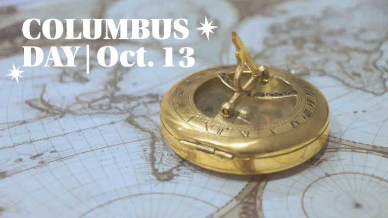The background is a photo of an antique world map in shades of light dusty blue and tan. Lying atop the map is a gold sundial compass. Overlaying the photo is large, serif white text that reads “COLUMBUS DAY | Oct. 13,” flanked by star-shaped eight-pointed star icons. The text is in the top left corner.