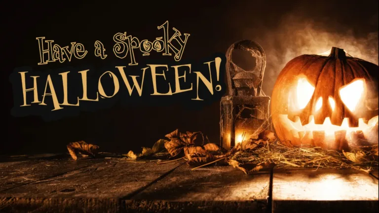 A photo of a jack-o-lantern and an old cast iron lamp covered and surrounded in spiderwebs and autumn leaves. Everything is on top of an old wooden table top and near or against the right edge of the graphic. The background is solid black. Against the black, on the left side are the words, ‘Have a Spooky Halloween!’ Halloween is below the rest of the words and is the largest in size. It uses an all-caps, yellow, serif font. The rest of the words above it use the same serif font, but are black with a gold outline.