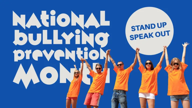 A solid blue background with a photo of five people standing beside one another is in the bottom right corner. The background has been removed from the photo, so only the blue background is seen. The people are all wearing bright orange t-shirts. They are all holding hands and reaching them up towards the sky. Above the people is a light gray circle. Inside it says, “STAND UP SPEAK OUT” in bold, blue sans letters. Stacked on the left side are these four words: National, Bullying, Prevention, Month. The words are light gray and use a sans font that looks like it was cut out of paper.