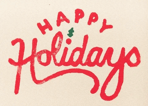 A light beige background with red handwritten words filling the gif. In large cursive letters is the word Holidays. A small green holly leaf sways above the I’s dot. In smaller sans letters, arched over holiday, is the word HAPPY.
