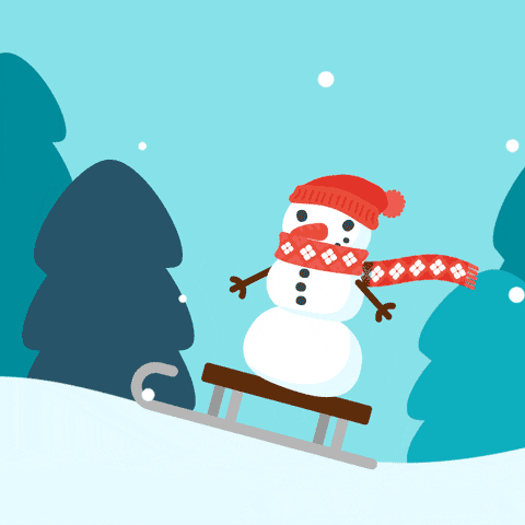 A happy snowman wearing a red scarf and hat rides on top of a wooden sled. The sled is traveling across snowy white hills. The snowman sleds past pine trees and a light blue sky.