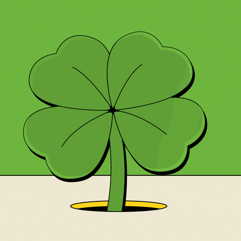 A bright green, four-leaf clover pops out out of a hole that opens up from the light tan ground. The clover then shrinks back into the hole and both disappear. The background is light green too.