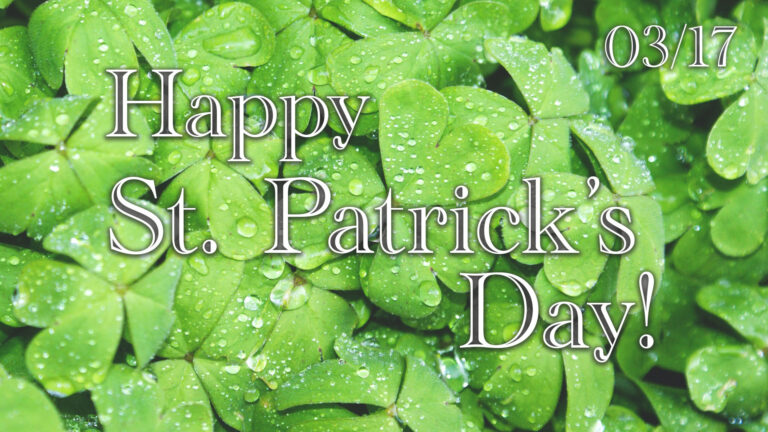 A close-ip photo of a dense patch of bright green four-leaf clovers covered in rain drops. Over top are the words, "Happy St. Patrick's Day!" A small date is in the top right corner: 03/17. The words and date use a decorative white serif font that has cut outs on their vertical lines.