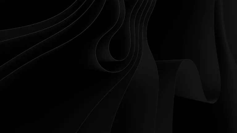 A black graphic with what appears to be waves and folds a crossed it. The shapes are also black and are only visible because a light source is hitting them.