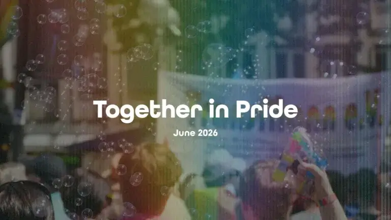 A darkened photo of a Pride parade with bubbles floating in the air. A faint rainbow glare covers the center of the graphic vertically. In the center is the message, "Together in Pride." A bold, white, sans font was used. Directly below, in small letters, is the date June 2026.