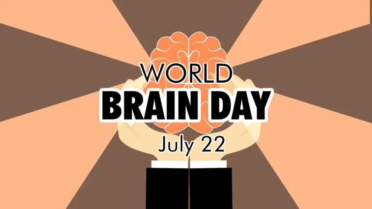 Two illustrated hands come up from the bottom edge's center. The two arms are covered with black sleeves and the edge of a while long-sleeve peaks out from their openings. The hands are cupped around the shape of a peach colored human brain. Four rays of light come from the brain and off the graphics edges. The rays are in a lighter shade of peach against a warm brown background. There are three lines of black, sans text stacked in the center. First 'world' in thin letters. Then 'Brain Day' is bolded in the center. Lastly, 'July 222' is at the bottom and thin. All the words have a white outline.